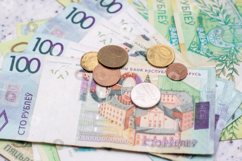 Скачать Экономия денег при обращении со стопкой зеленых банкнот и розовых монет на столе фотосток Ozero