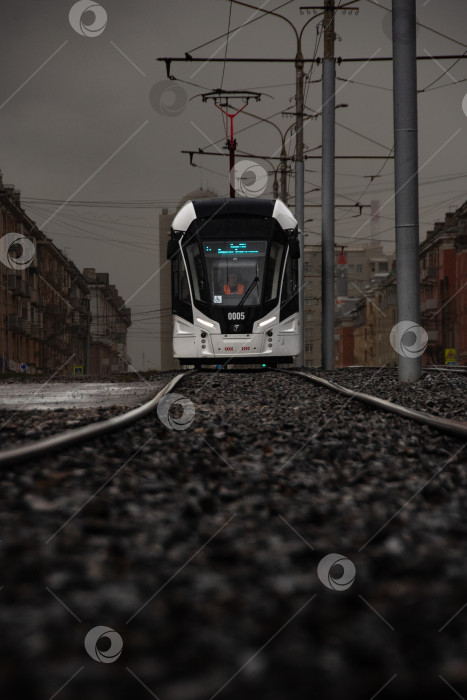 Скачать трамвай на фоне города, городской пейзаж. Россия Красноярск апрель 2024 фотосток Ozero