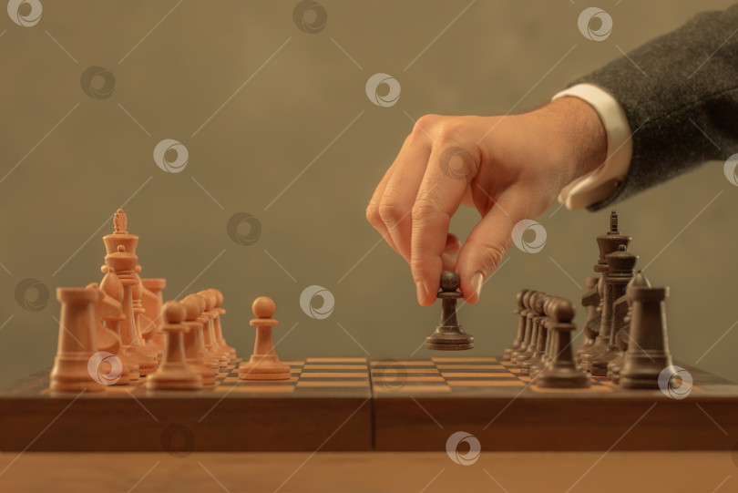 Скачать Рука, держащая шахматную фигуру. фотосток Ozero