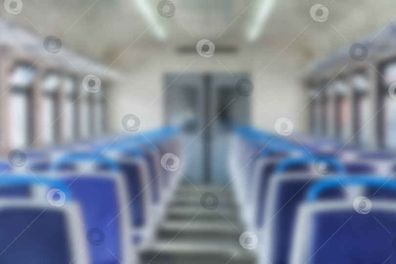 Скачать Общий вид интерьера пассажирского электропоезда в размытом виде (задний план) фотосток Ozero