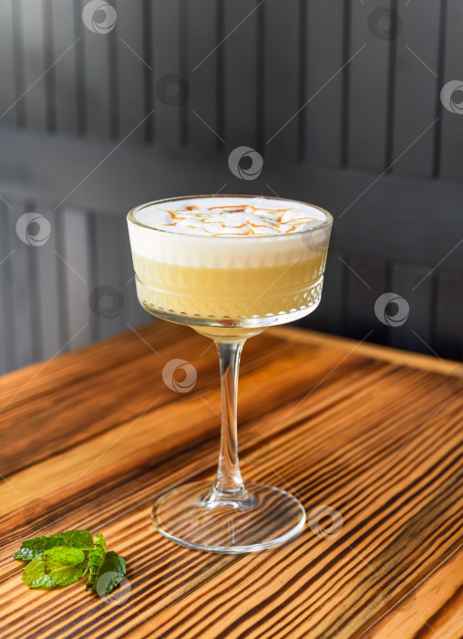 Скачать Алкогольный коктейль Whisky sour на деревянном столе на фоне темной стены с пространством для копирования фотосток Ozero
