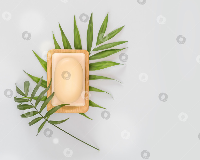 Скачать Кусочки натурального мыла или сухого шампуня на деревянной подставке с пальмовыми листьями на синем фоне фотосток Ozero