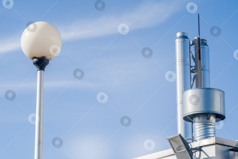 Скачать блестящие металлические вентиляционные трубы на фоне голубого неба фотосток Ozero