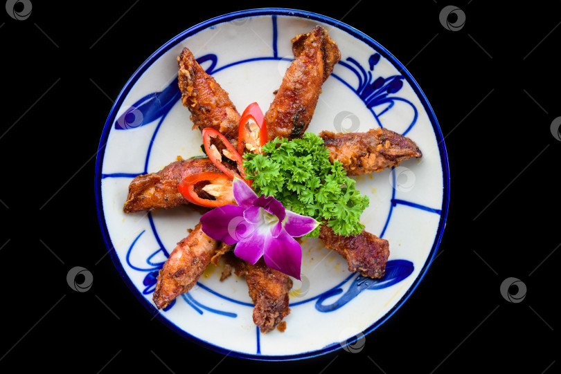 Скачать Жареные кальмары с овощами на черном фоне для меню фотосток Ozero