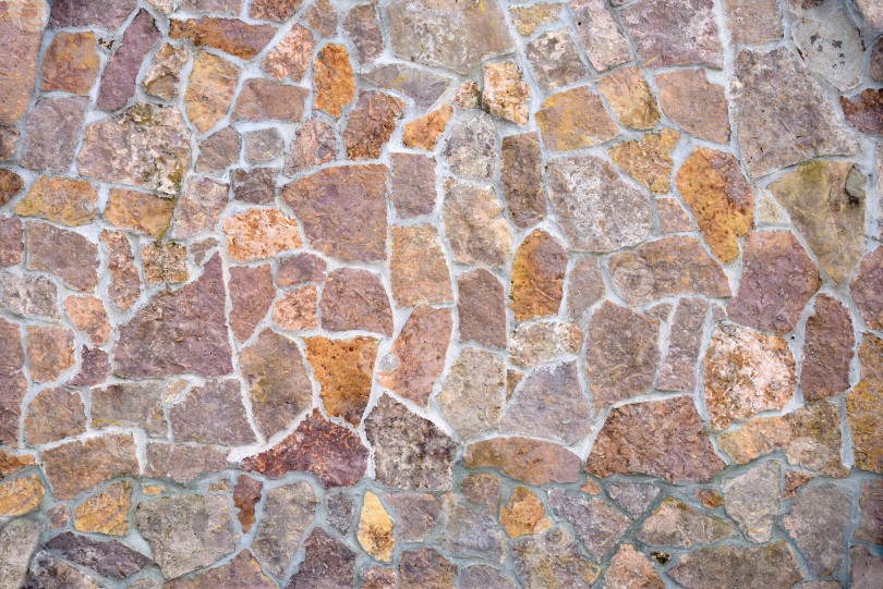 Скачать Каменная стена с различными фрагментами плитки. Фон фотосток Ozero