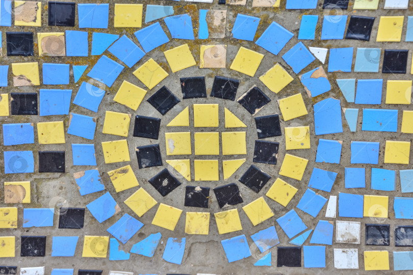 Скачать цветная мозаика и узор из круглой плитки на старой стене. декоративная мозаика синего, желтого и черного цветов фотосток Ozero