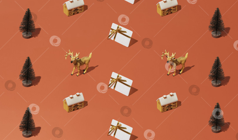 Скачать Рождественский узор с различными зимними и новогодними элементами: домиками, елками, северными оленями, подарочными и кредитными картами фотосток Ozero