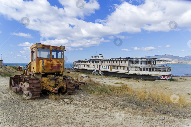 Скачать На берегу моря стоит старая заброшенная речная лодка. фотосток Ozero