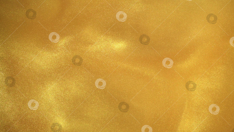 Скачать Желто-золотистый блестящий абстрактный фон. Краски, акрил, блестки в воде. фотосток Ozero