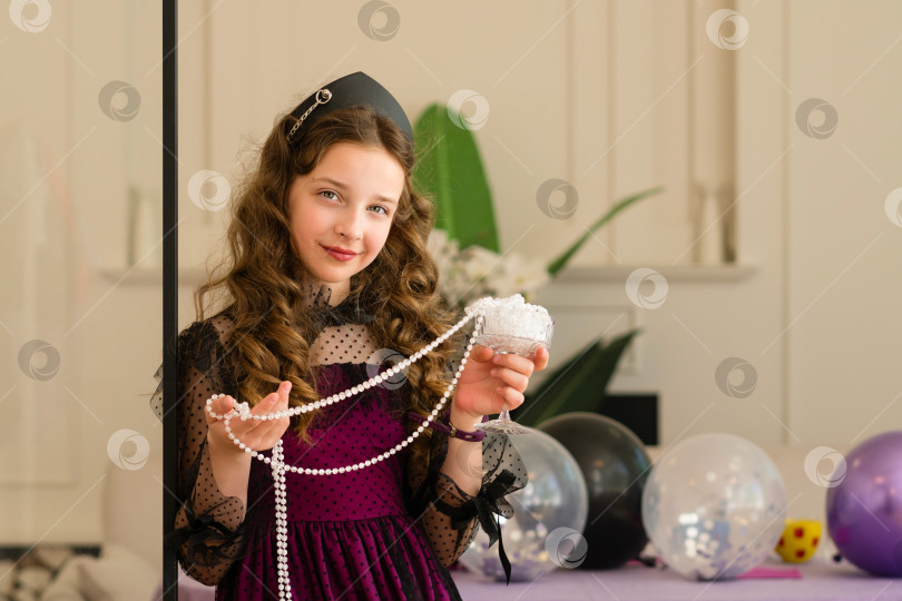 Скачать Девушка держит в руках жемчуг и улыбается на праздновании дня рождения. фотосток Ozero