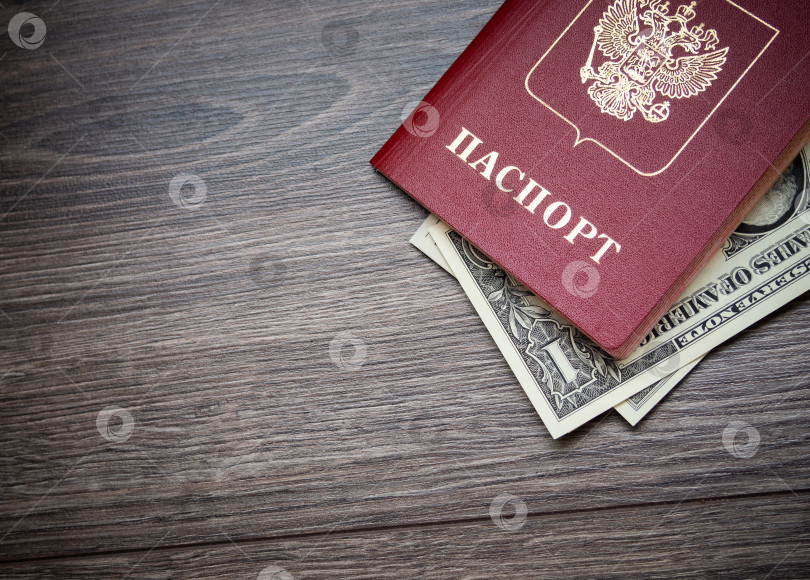 Скачать Заграничный паспорт и доллары на деревянном фоне. фотосток Ozero