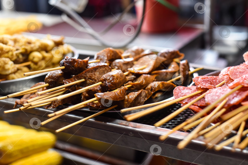 Скачать Приготовленные на гриле сосиски и салями барбекю в Jalan Alor street food в Куала-Лумпуре фотосток Ozero