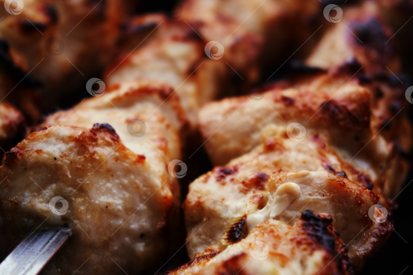 Скачать Приготовление мяса на гриле, барбекю, кусочки мяса насаживаются на шампур. Запекание шашлыка на углях фотосток Ozero