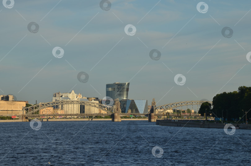 Скачать Санкт-Петербург, Россия – 06.12.2024: Большеохтинский мост (мост Императора Петра Великого) в Санкт-Петербурге, вид на Малоохтинскую набережную и бизнес-центр Санкт-Петербург Плаза фотосток Ozero