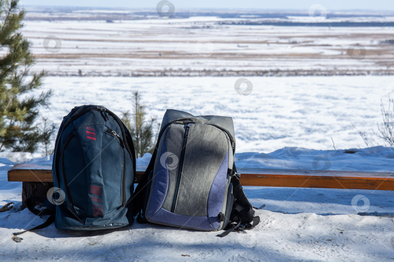 Скачать Два рюкзака возле скамейки зимой фотосток Ozero