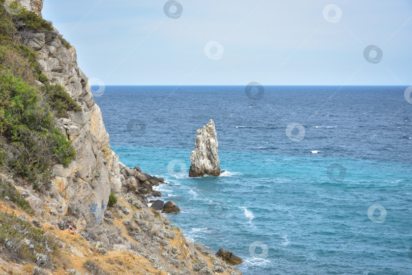 Скачать кусок скалы у моря недалеко от побережья, вид на прибрежные скалы возле замка Ласточкино гнездо в Крыму, отдельно стоящий большой кусок скалы посередине, береговая линия слева, вид на море фотосток Ozero