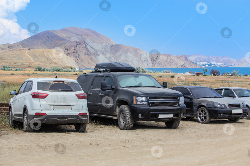 Скачать Автомобили на стоянке у морского побережья фотосток Ozero