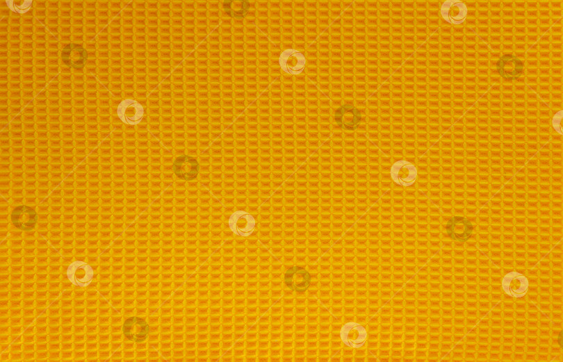 Скачать Оранжевый абстрактный фон. Натуральная хлопчатобумажная вафельная ткань, текстура ткани. Вид сверху, крупным планом. фотосток Ozero