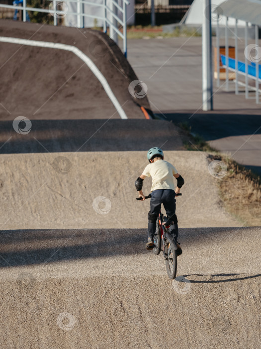 Скачать Мальчик-гонщик на грунтовой гоночной трассе BMX фотосток Ozero