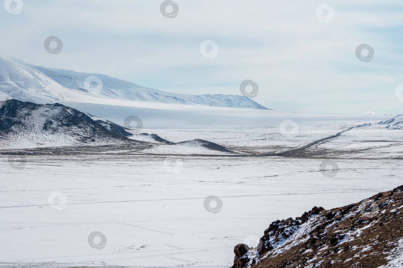 Скачать Дорога лежит далеко, через заснеженные холмы. Монголия. фотосток Ozero