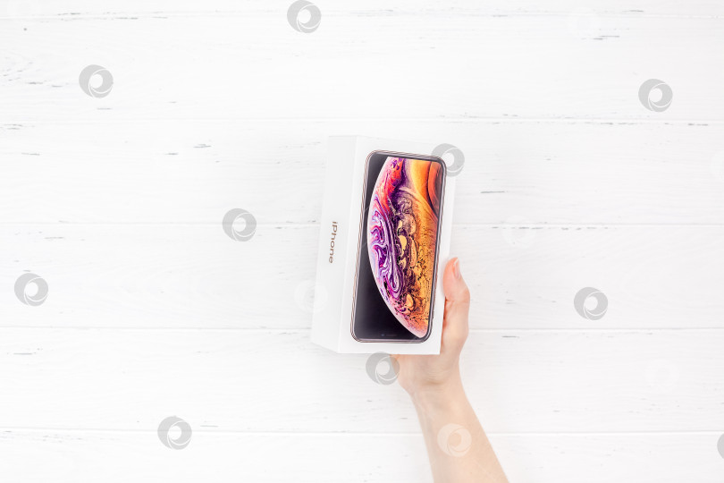 Скачать Женские руки с новейшей коробкой Apple iPhone XS фотосток Ozero