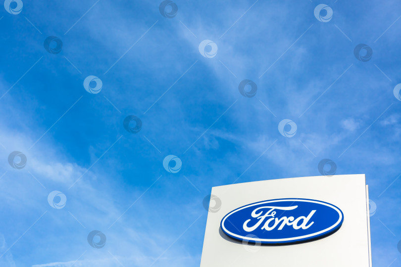 Скачать Логотип бренда Ford на фоне ярко-голубого неба фотосток Ozero