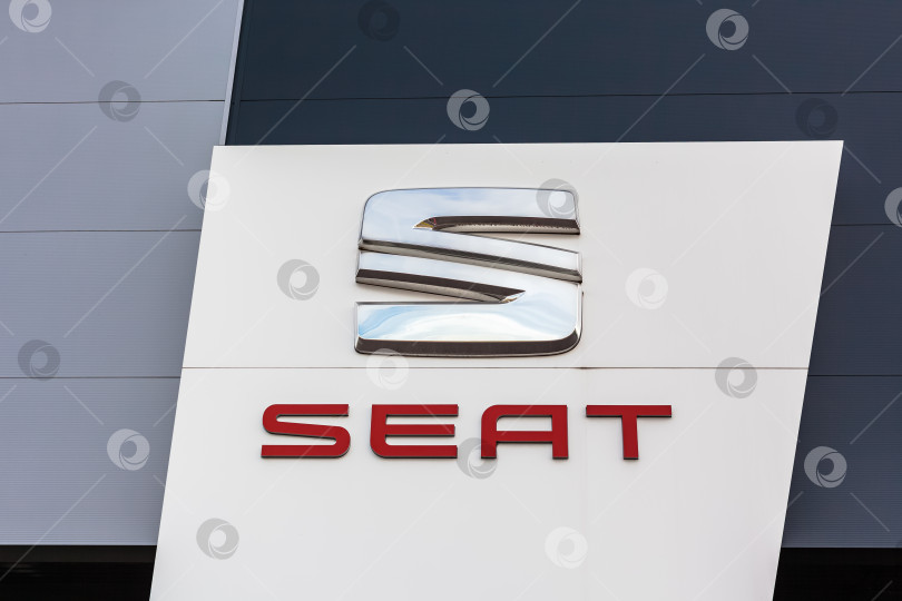 Скачать Логотип бренда SEAT на фоне ярко-голубого неба фотосток Ozero