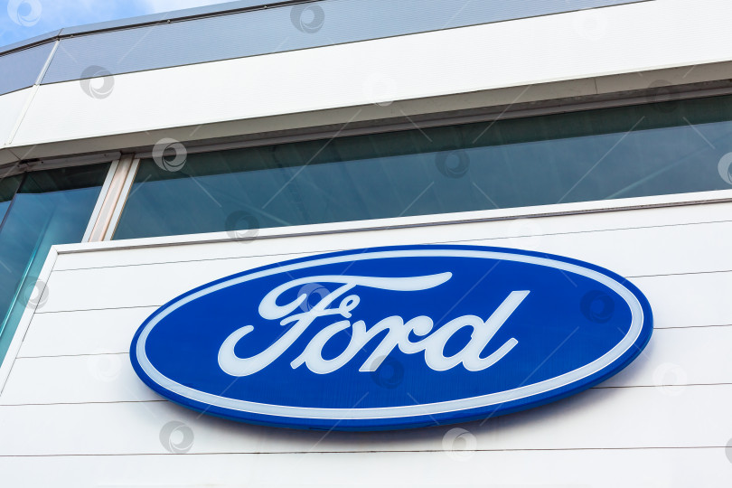 Скачать Логотип бренда Ford на фоне ярко-голубого неба фотосток Ozero