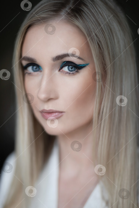 Скачать портрет блондинки крупным планом с красивыми изумрудными стрелками в глазах фотосток Ozero