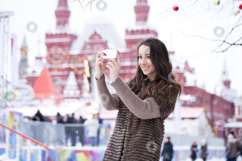 Скачать Молодая красивая туристка фотографирует на мобильный телефон фотосток Ozero