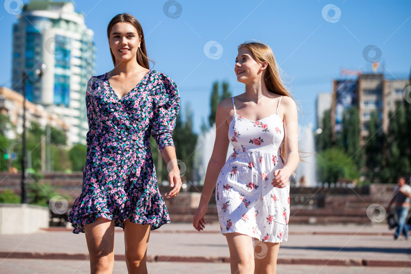 Скачать Две счастливые подружки-подростка прогуливаются по летнему парку. фотосток Ozero