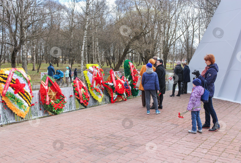 Скачать Люди вешают венки на забор. фотосток Ozero