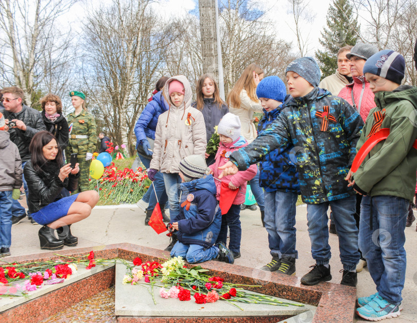 Скачать Подросток бросает монетку в Вечный огонь. фотосток Ozero