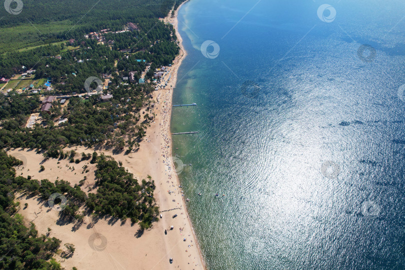 Скачать Песчаный пляж на берегу моря в солнечный летний день. Курортный отдых на берегу моря. фотосток Ozero