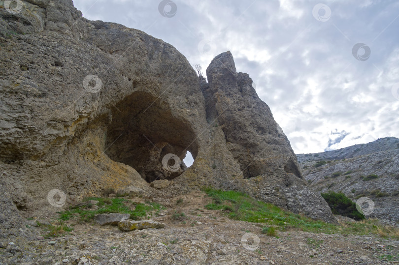 Скачать Небольшой сквозной грот в скале. фотосток Ozero