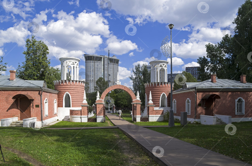Скачать Въездные ворота в парк старинной усадьбы на фоне современного здания. фотосток Ozero