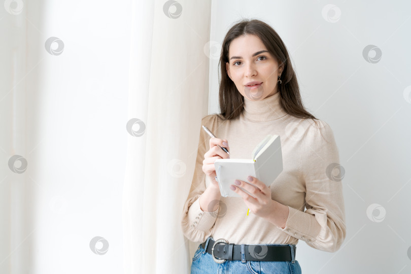Скачать Женщина держит в руках книгу и ручку фотосток Ozero