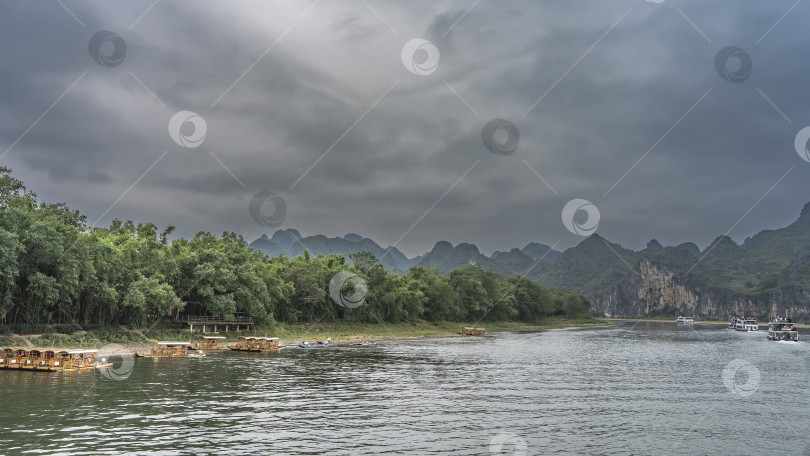 Скачать К берегу реки пришвартованы бамбуковые плоты. фотосток Ozero