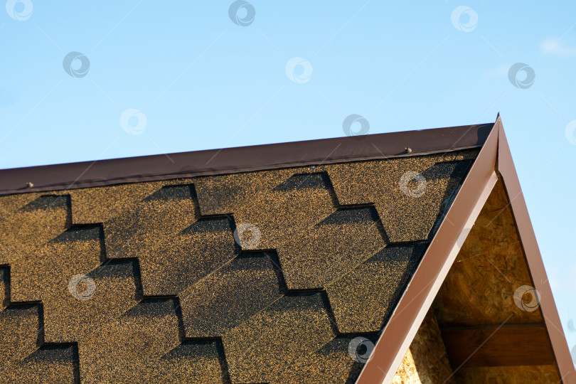Скачать Вид на металлический конек крыши. Крыша покрыта мягкой черепицей фотосток Ozero
