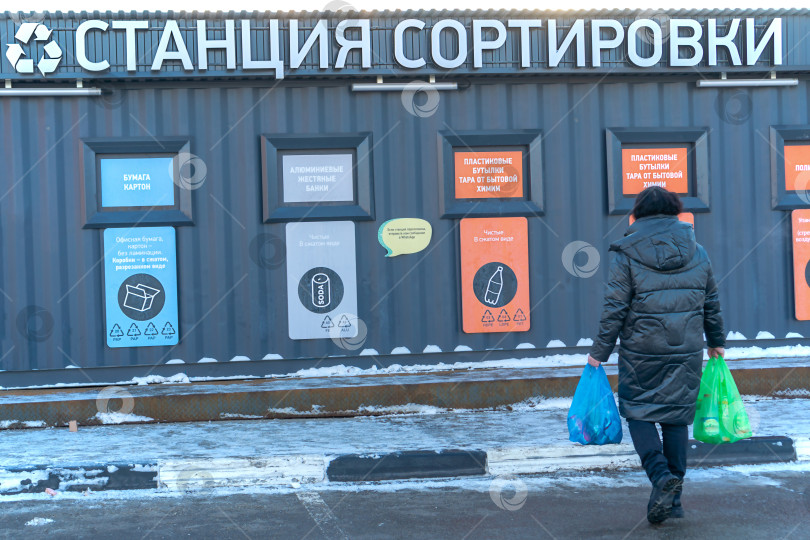 Скачать Женщина несет мешки с мусором на сортировку. Вид сзади. Россия, Татарстан, 04 декабря 2020 г. фотосток Ozero