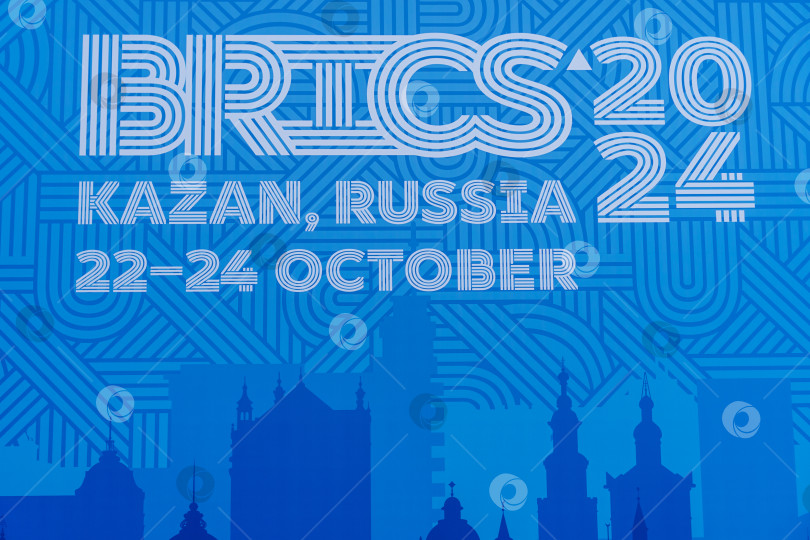 Скачать Надпись крупным планом "БРИКС-2024", Казань, Россия, 22-24 октября на синем фоне. Официальный синий логотип саммита БРИКС-2024 в Казани. Россия, Казань, 26 октября 2024 г. фотосток Ozero