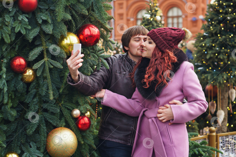 Скачать Влюбленные гуляют на рождественской ярмарке фотосток Ozero