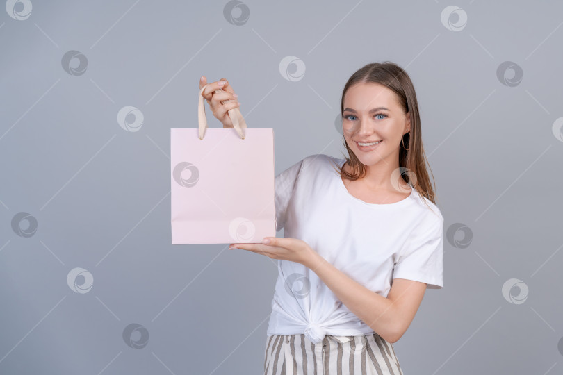 Скачать Сезонные распродажи и покупки. Портрет очаровательной счастливой покупательницы, прогуливающейся фотосток Ozero