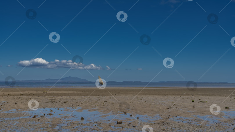 Скачать Отлив в океане. Вдали виден одинокий парусник. фотосток Ozero