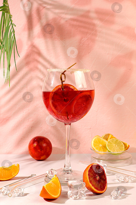 Скачать Королевский коктейль aperol sprits с кровавым апельсином, кубиками льда, ромом и текилой. Концепция летней вечеринки и отдыха в ресторане. Баннер с бокалами алкогольных напитков и тропическими фруктами. Меню для бара или кафе. фотосток Ozero