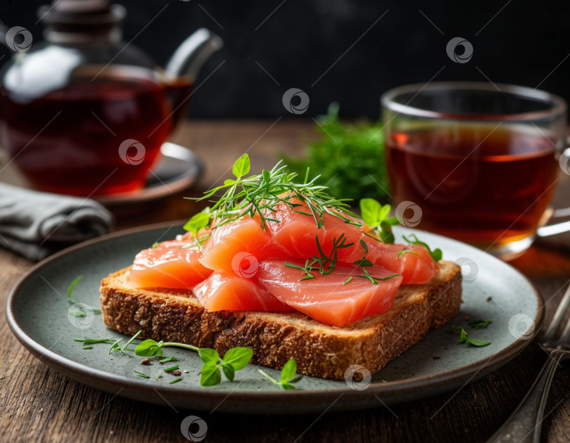 Скачать Тост с фарелем из красной рыбы, зеленью и чашкой чая. Создано с помощью искусственного интеллекта фотосток Ozero