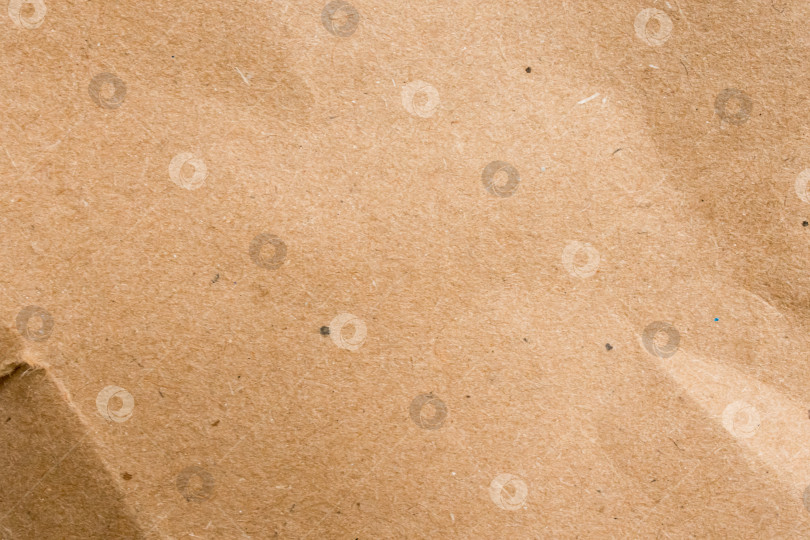 Скачать Крупный план поверхности коричневой текстурированной бумаги с едва заметными складками фотосток Ozero