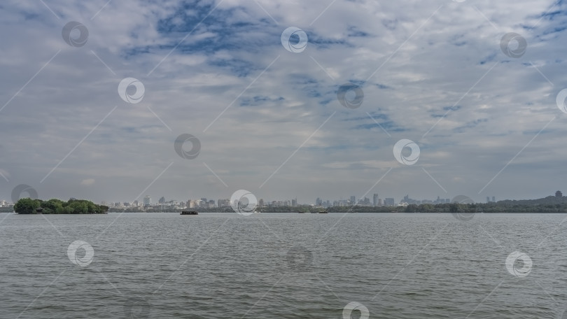 Скачать Пейзаж красивого спокойного городского озера. Рябь на поверхности. фотосток Ozero