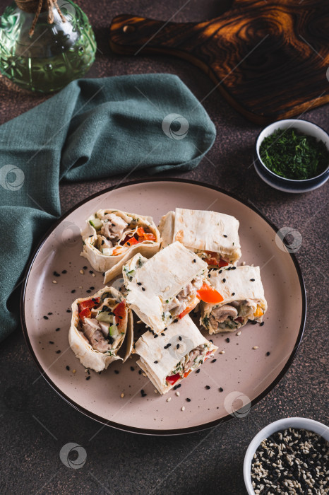 Скачать Плоские булочки с курицей и овощами на тарелке на столе, вид сверху фотосток Ozero