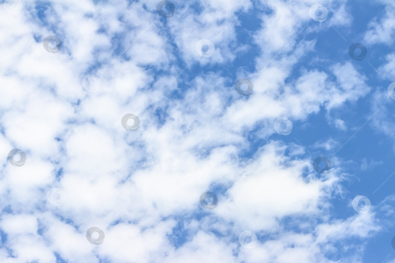 Скачать Обширное голубое небо, наполненное пушистыми белыми облаками, создает безмятежную атмосферу, идеально подходящую для создания фона или дизайнерских проектов с пространством для копирования текста. фотосток Ozero